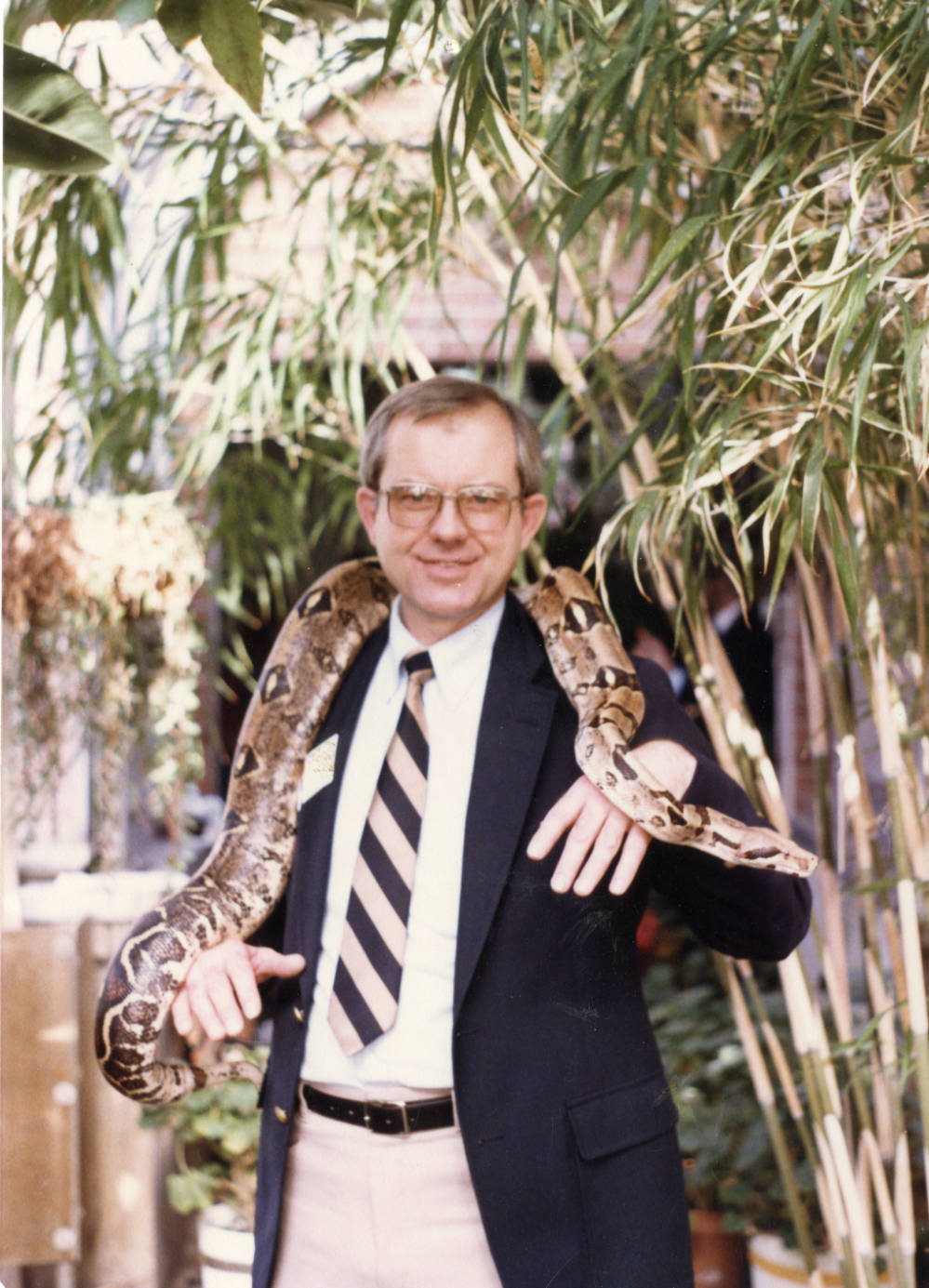 Image of Jim Olson holding a snake. 