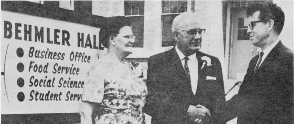 Fred W. Behmler and Rodney A. Briggs shaking hands outside of the newly renamed Behmler Hall