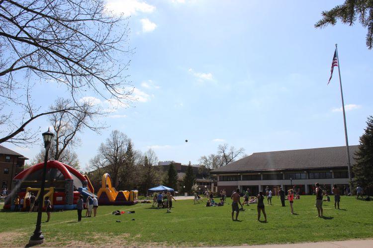 Students play games and enjoy inflatables on the Campus Mall on a sunny day